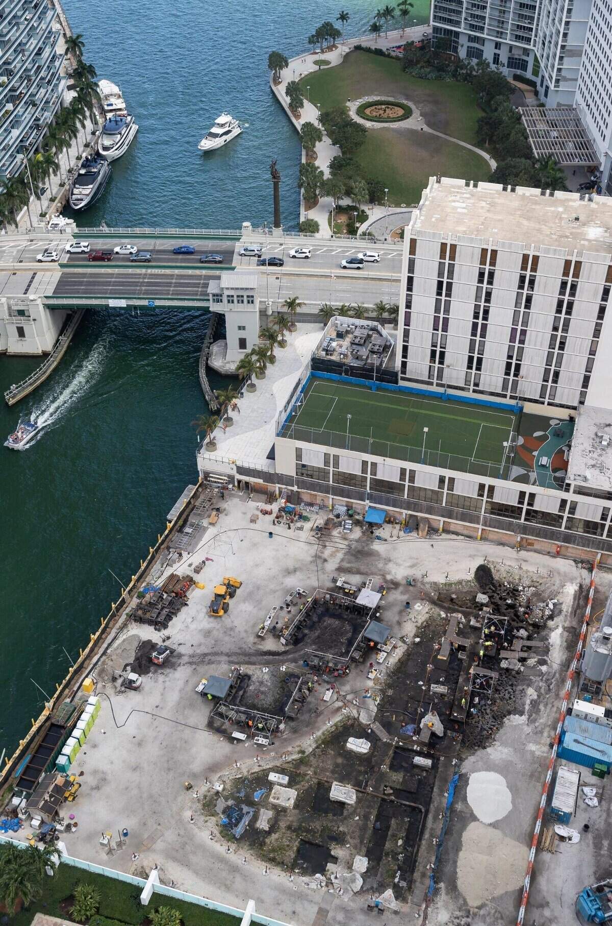 An 2023 aerial photograph shows the site of an archaeological dig, at bottom, that uncovered remnants of a prehistoric indigenous village on the Miami River across Brickell Avenue from the 2,000-year-old Miami Circle, visible at top. Developer Related Group built two residential towers on the river site after excavation was completed.